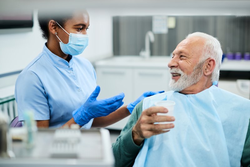 patient receiving dentures from dentist