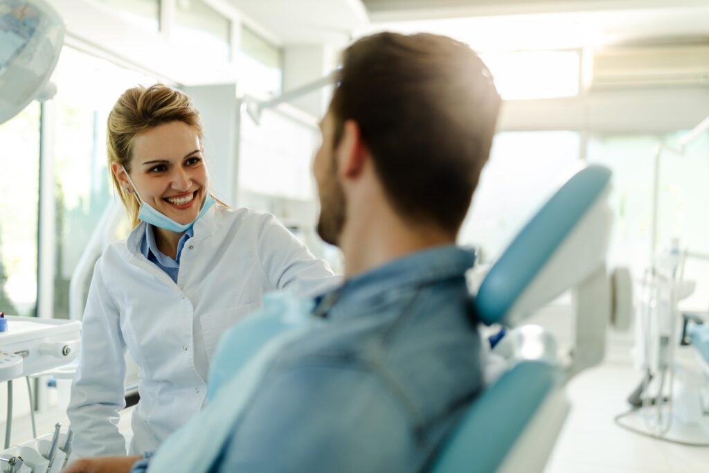 Dentist smiling at patient during exam